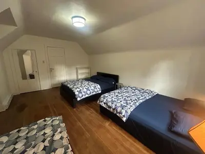 a bedroom with two beds in a room at Vancouver Guest House - Airport 10 Min - Free Parking & Fast Wi-Fi in Vancouver