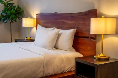 a bedroom with a bed with two lamps on tables at Alpine Chic - two-story mtn escape near downtown in Canmore