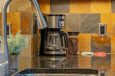 a coffee maker on a counter in a kitchen at Rundle Range Retreat Lux Mtn View Condo near dt in Canmore