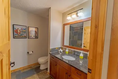 a bathroom with a sink and a toilet at Rundle Range Retreat Lux Mtn View Condo near dt in Canmore