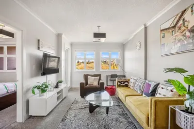 a living room with a couch and a table at Stylish & Romantic Riverside Stay in Downtown in Calgary