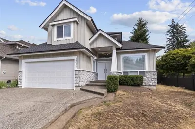a white house with a white garage at Spacious 2 BED close to BEACH, Highway & US BORDER in Surrey