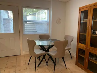 a dining room with a glass table and chairs at Spacious 2 BED close to BEACH, Highway & US BORDER in Surrey