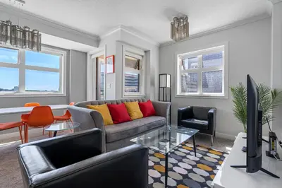 a living room with a couch and a table at Delightful 2 BR And 2 Bath Water View in Downtown in Calgary