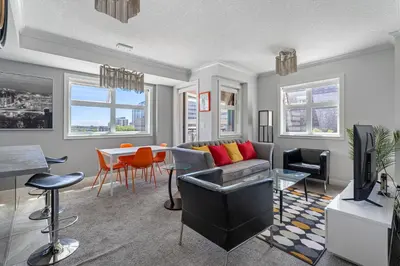 a living room with a couch and a table at Delightful 2 BR And 2 Bath Water View in Downtown in Calgary