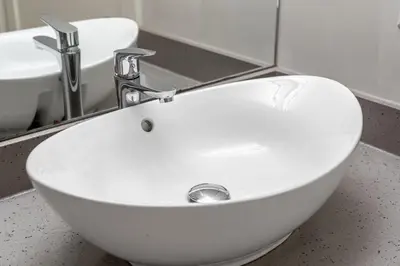 a white sink in a bathroom with a mirror at Delightful 2 BR And 2 Bath Water View in Downtown in Calgary