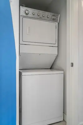 a white stove in a kitchen with a refrigerator at Waterfront 2 Beds And 2 Bath Downtown Urban Escape in Calgary