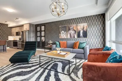 a living room with a couch and a table at Lovely 3BR unit in the heart of Calgary in Calgary