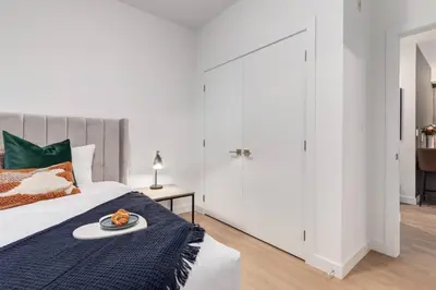 a bedroom with a bed with a plate of food on it at Lovely 3BR unit in the heart of Calgary in Calgary
