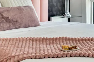 a tray with a plate of food on a bed at Modern 3BR unit in the heart of Calgary in Calgary