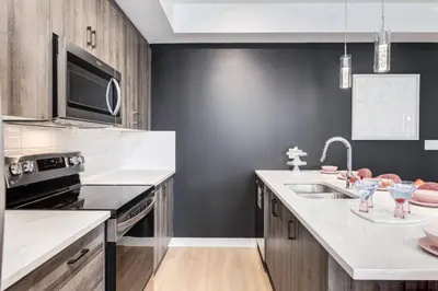 a kitchen with a sink and a microwave at Modern 3BR unit in the heart of Calgary in Calgary