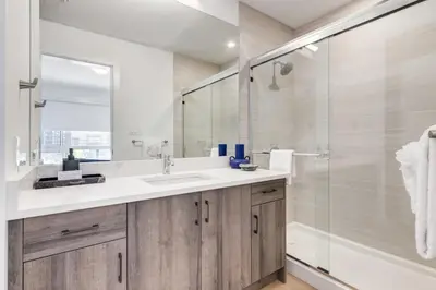 a bathroom with a sink and a shower at Cozy 3BR unit with Arcade in the heart of Calgary in Calgary
