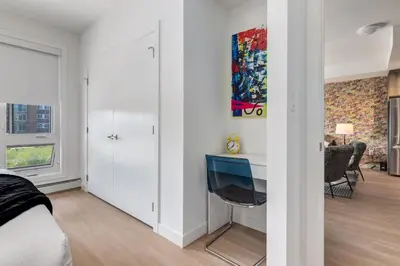 a bedroom with a bed and a desk at Cozy 3BR unit with Arcade in the heart of Calgary in Calgary