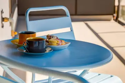 a blue table with two cups and a plate of food at Cozy 3BR unit with Arcade in the heart of Calgary in Calgary