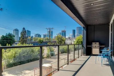 a balcony with a view of the city at Cozy 3BR unit with Arcade in the heart of Calgary in Calgary