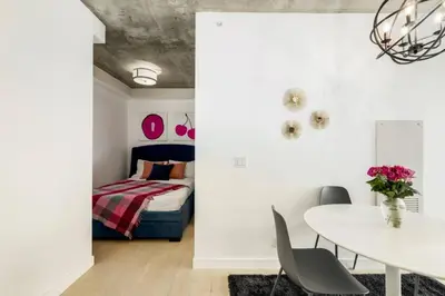 a dining room with a table and a bed at Spacious and Stylish Modern Condo in Calgary in Calgary