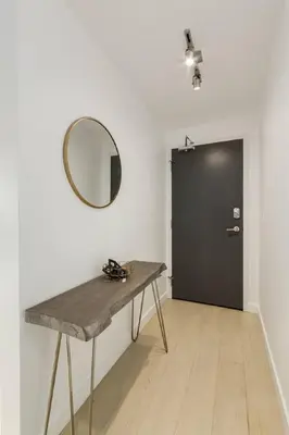 a room with a table and a mirror and a door at Spacious and Stylish Modern Condo in Calgary in Calgary