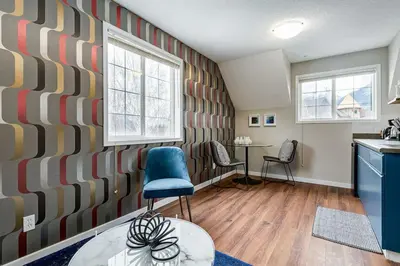 a kitchen with a blue chair and a table at Cozy and Stylish Stay in Mountain View Condo in Canmore