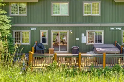 a green house with a bed on the porch at Rockies Escape Skiing Hiking and Private Hot Tub in Golden