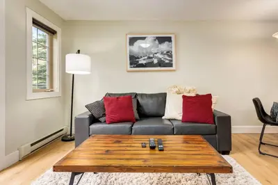 a living room with a couch and a coffee table at Rockies Escape Skiing Hiking and Private Hot Tub in Golden