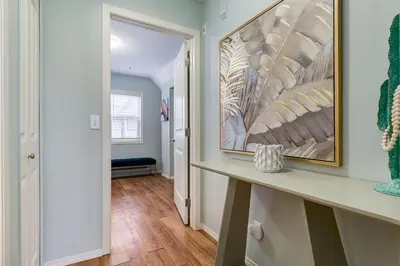 a hallway of a home with a table and a painting at The Cutest Condo in Canmore and Banff in Canmore