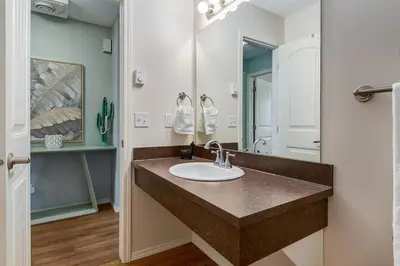 a bathroom with a sink and a mirror at The Cutest Condo in Canmore and Banff in Canmore