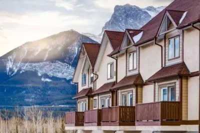 a row of houses in front of a mountain at The Cutest Condo in Canmore and Banff in Canmore
