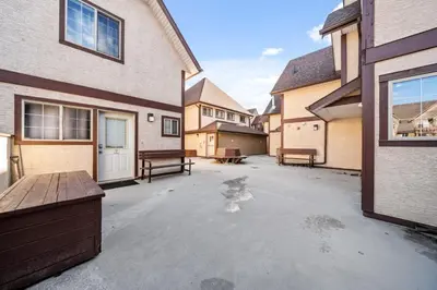 an empty parking lot in front of a house at The Most Perfect Stay in Canmore with Mountain View in Canmore