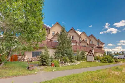 a large house with a road in front of it at Stunning Mountain View Cozy Studio for Small Grp in Canmore