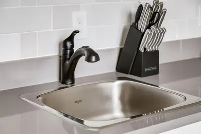 a kitchen sink with a faucet and a knife block at The Perfect Getaway for Exploring Canmore and Banff) in Canmore