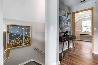 a hallway with a painting on the wall and a table at The Perfect Getaway for Exploring Canmore and Banff) in Canmore