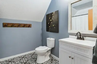 a bathroom with a toilet and a sink and a mirror at The Perfect Getaway for Exploring Canmore and Banff) in Canmore