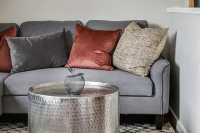 a living room with a couch and a table with pillows at The Perfect Getaway for Exploring Canmore and Banff) in Canmore