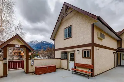 a house with a bench in front of it at Charming and Stylish renovated Condo near Banff in Canmore
