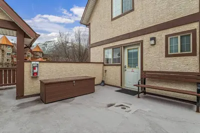 a house with a bench in front of it at Charming and Stylish renovated Condo near Banff in Canmore