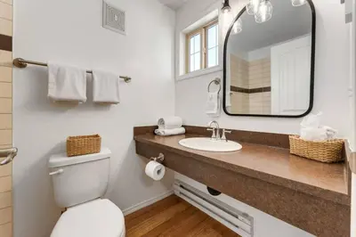 a bathroom with a sink and a mirror at Cozy Tropical Vibe Haven in Canmore near Banff in Canmore