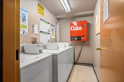 a bathroom with a coke sign on the wall at Cozy Tropical Vibe Haven in Canmore near Banff in Canmore