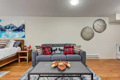 a living room with a couch and a table at Charming Condo In The Heart Of Canmore in Canmore