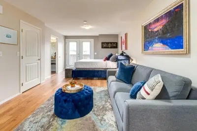 a living room with a couch and a bed at Cozy Condo in the Heart of Canmore in Canmore