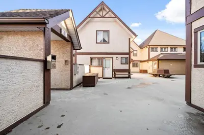 an empty parking lot in front of a house at Cozy Condo in the Heart of Canmore in Canmore