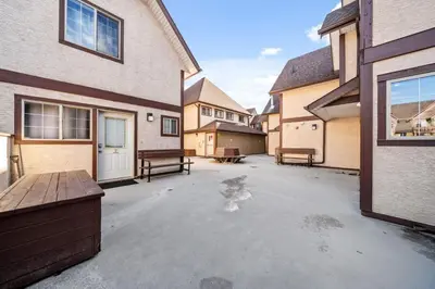 an empty parking lot in front of a house at Stylish Getaway in the Heart of Canmore near Banff in Canmore