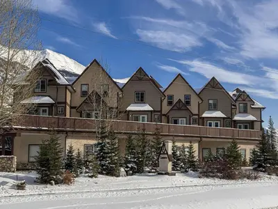 a large house with snow on the roof at Stylish Getaway in the Heart of Canmore near Banff in Canmore