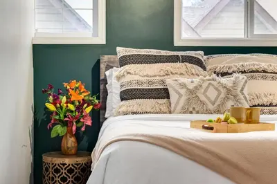 a bedroom with a bed with a box of fruit on it at Delightful 2BR Mountain Escape in Canmore in Canmore