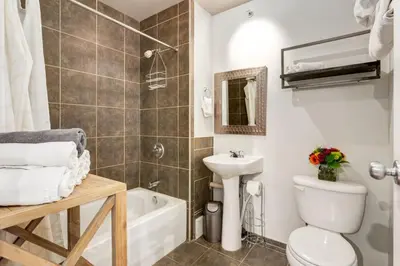 a bathroom with a toilet and a sink and a bath tub at Delightful 2BR Mountain Escape in Canmore in Canmore