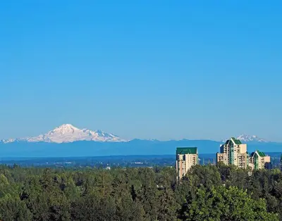 a view of a city with a mountain in the background at Luxury & Spacious three bedrooms House Near Coquitlam Town Centre in Coquitlam