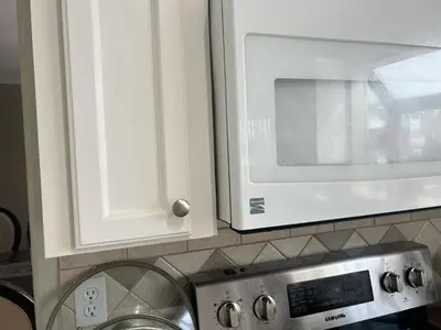 a kitchen counter with a microwave and a stove at Luxury & Spacious three bedrooms House Near Coquitlam Town Centre in Coquitlam