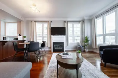 a living room with a couch and a fireplace at Downtown Edmonton Suite: 5-Min Drive to Rogers in Edmonton