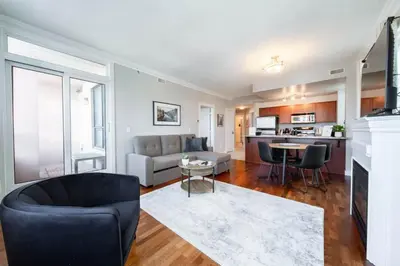 a living room with a couch and a table at Downtown Edmonton Suite: 5-Min Drive to Rogers in Edmonton