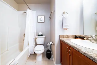 a bathroom with a toilet and a sink at Downtown Edmonton Suite: 5-Min Drive to Rogers in Edmonton