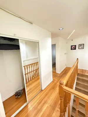 an empty room with stairs and a mirror at Cozy Private Room near Langara College Skytrain Station in Vancouver